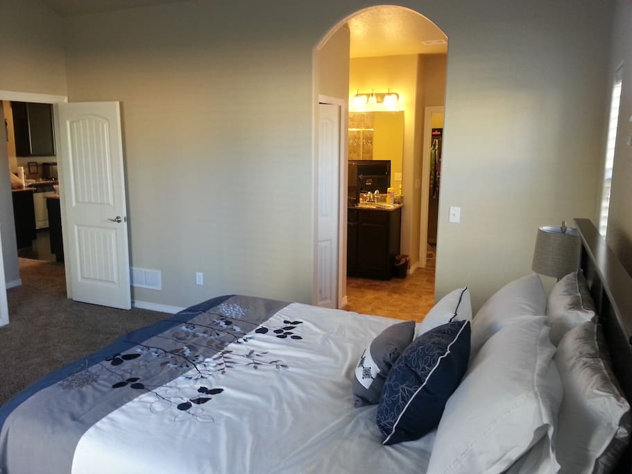 Master bedroom on the main floor, peaking out to the kitchen. Laundry is just to right outside the master bedroom.