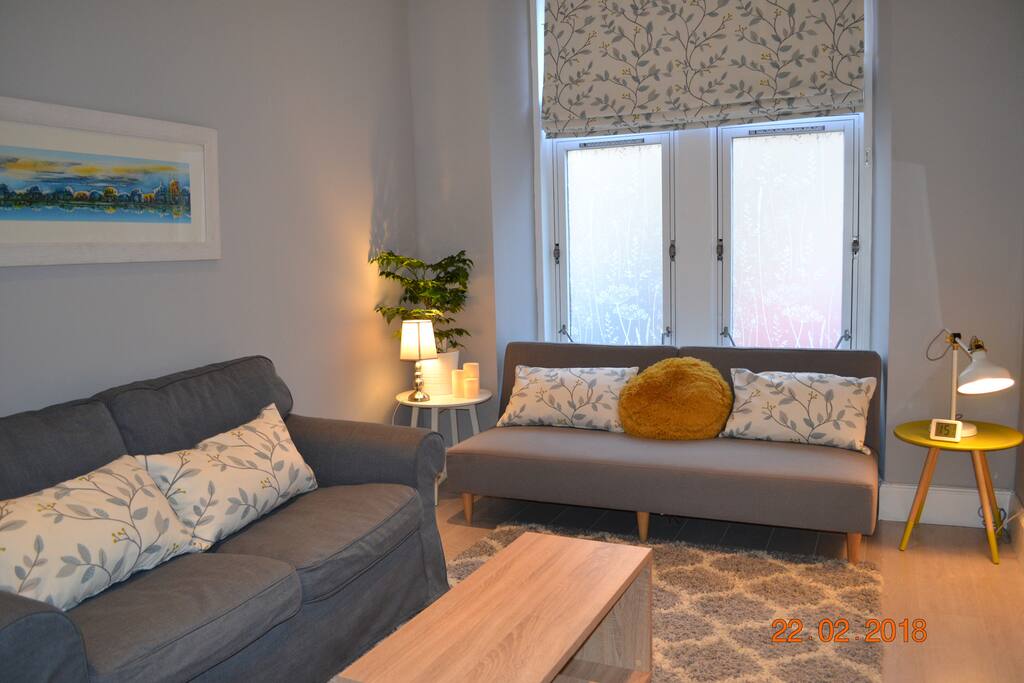 The living room has two comfortable sofas and a wide screen tv.