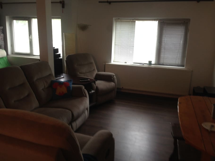 3 person sofa and 2 armchairs for watching the wall projector. Cable TV and Internet. USB devices available to watch your own movies.