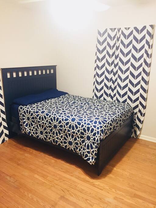 Bedroom 1 on first floor. Full size bed. 42’ flat screen television. Hardwood floor. Ceiling fan with light fixture. Two Pella windows with screens and treatments.