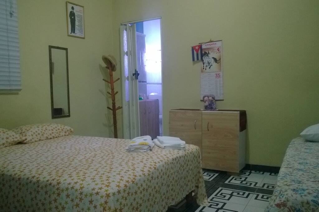 The bedroom has two beds, one double and one single, air conditioning, a small closet and a TV.