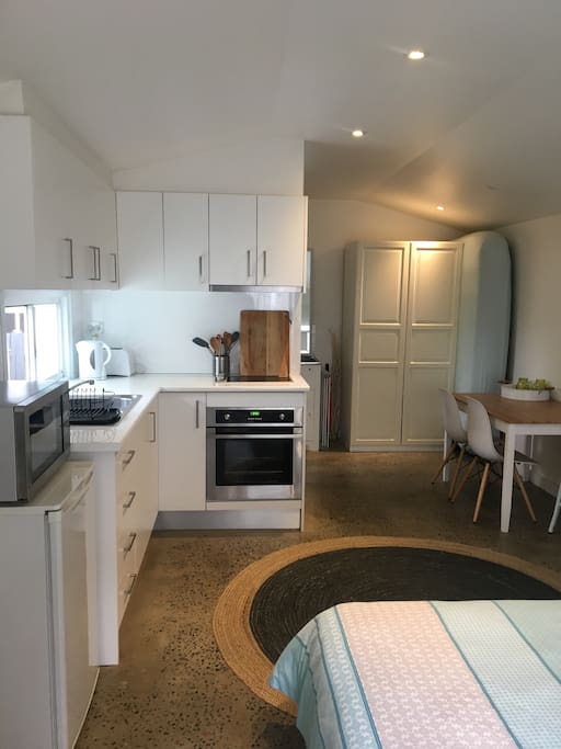 Kitchen with full size oven / cooktop / microwave / fridge / wardrobe