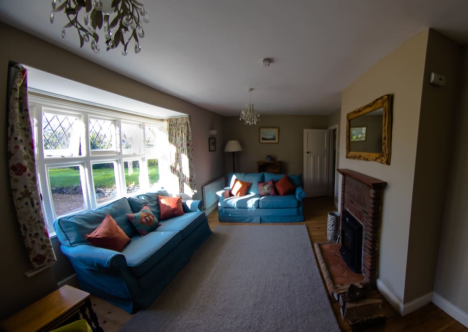 Large sitting room with wood-burning fireplace