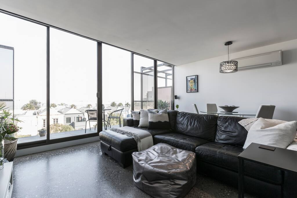 Comfortable leather couch and polished concrete floors
