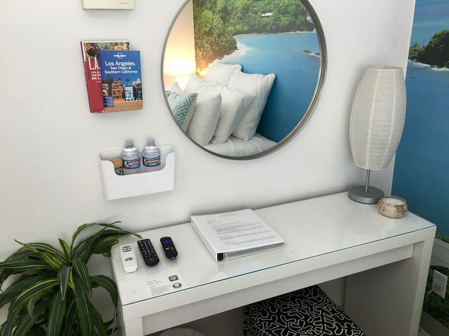 Dressing table with bottled water, Clif bars, LA guidebooks