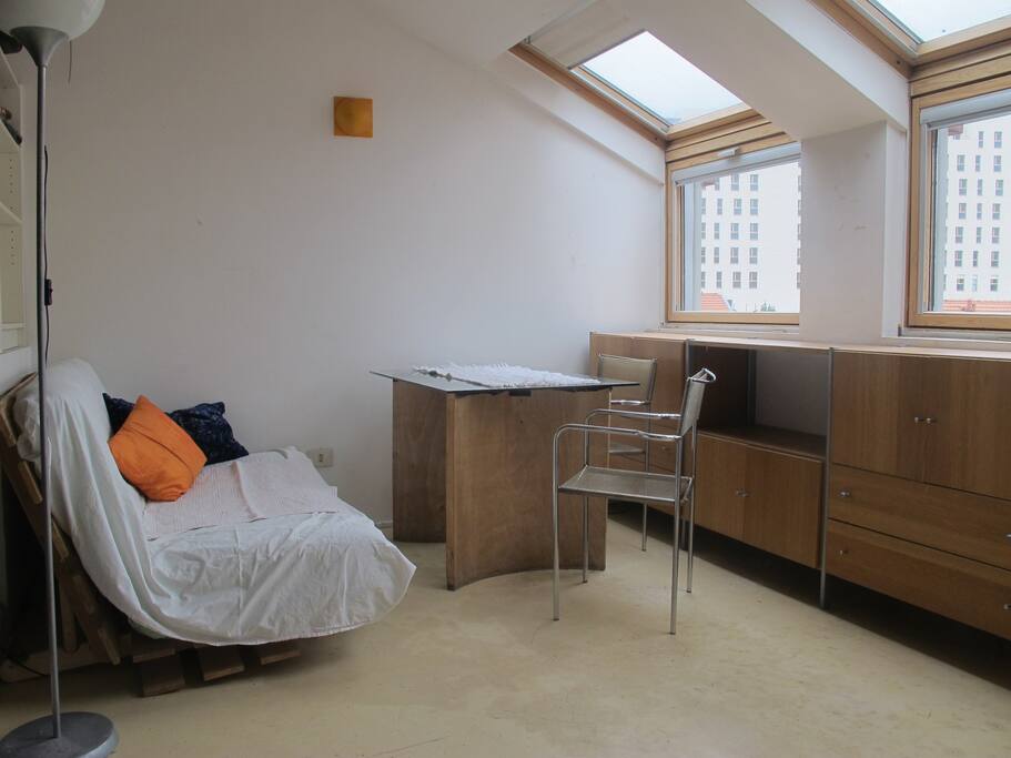 Main bright room with sofa/futon bed in photo.