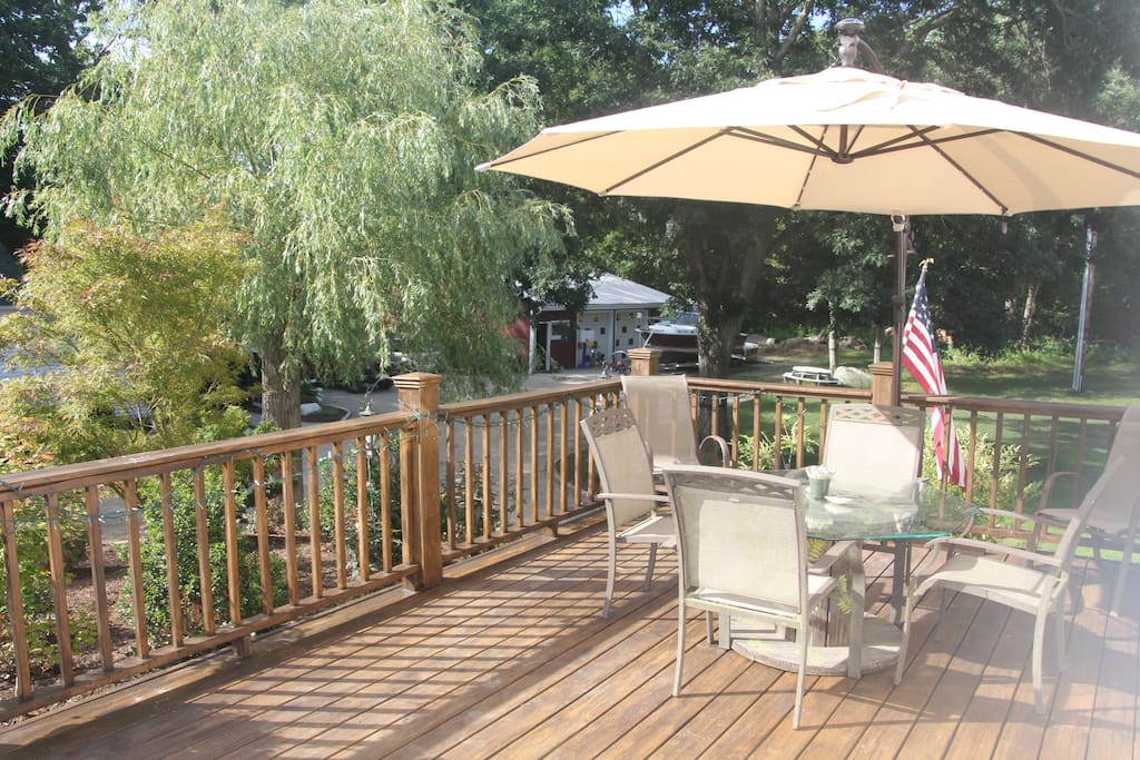 Shaded deck with gas grill.