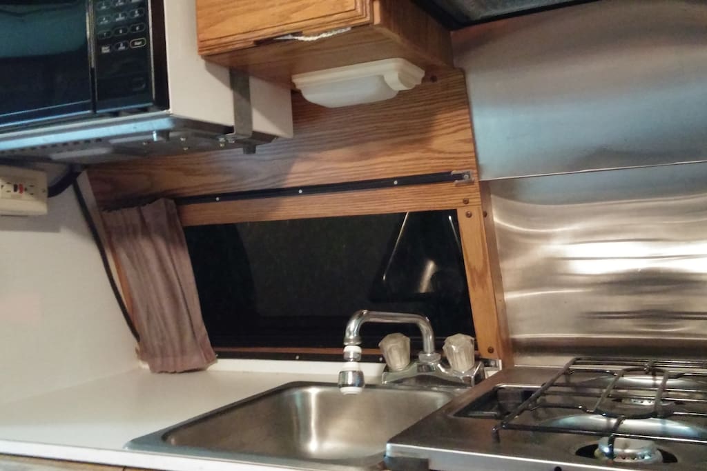 Sink and gas range (microwave usage not available).