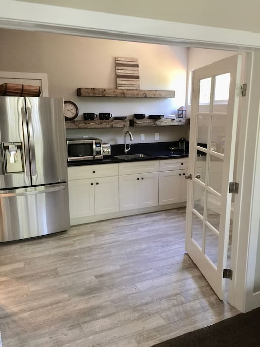 Enjoy complimentary coffee in large kitchen w french doors, slate counter tops and all new appliances including a full refrigerator w filtered water
