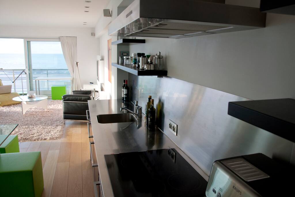 A modern, functional kitchen, connected with a beautiful stylish living room
