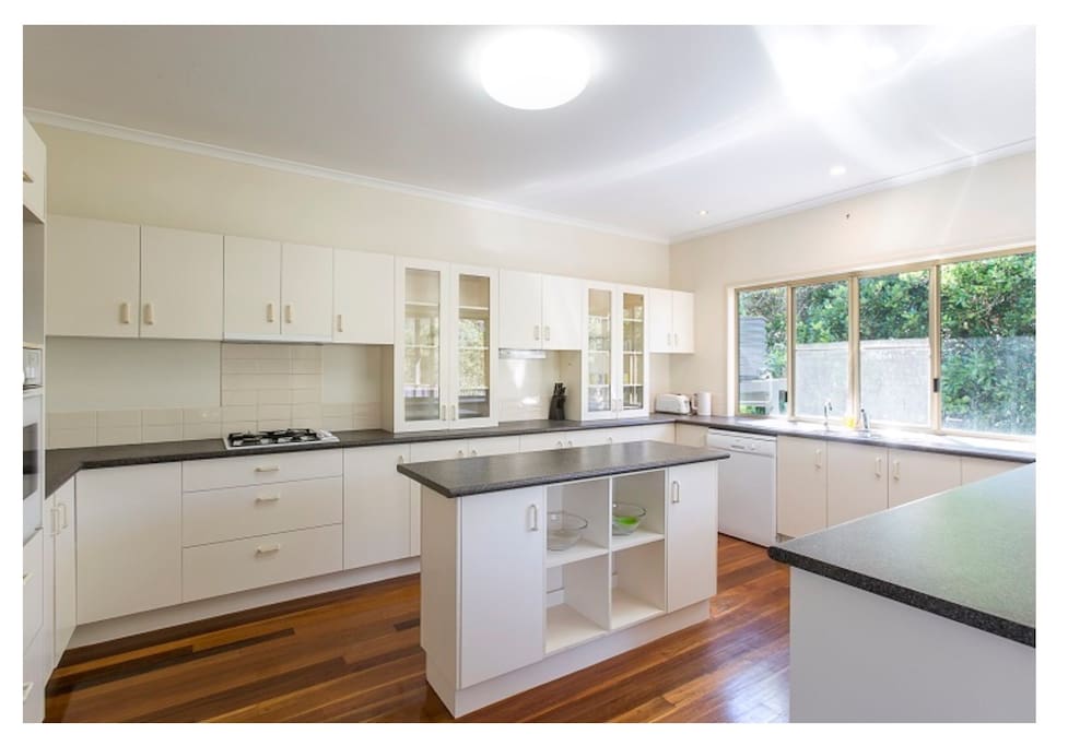 Huge family kitchen with dishwasher, microwave, cooktop, oven and most importantly, a coffee maker - Aldi brand for coffee pods.