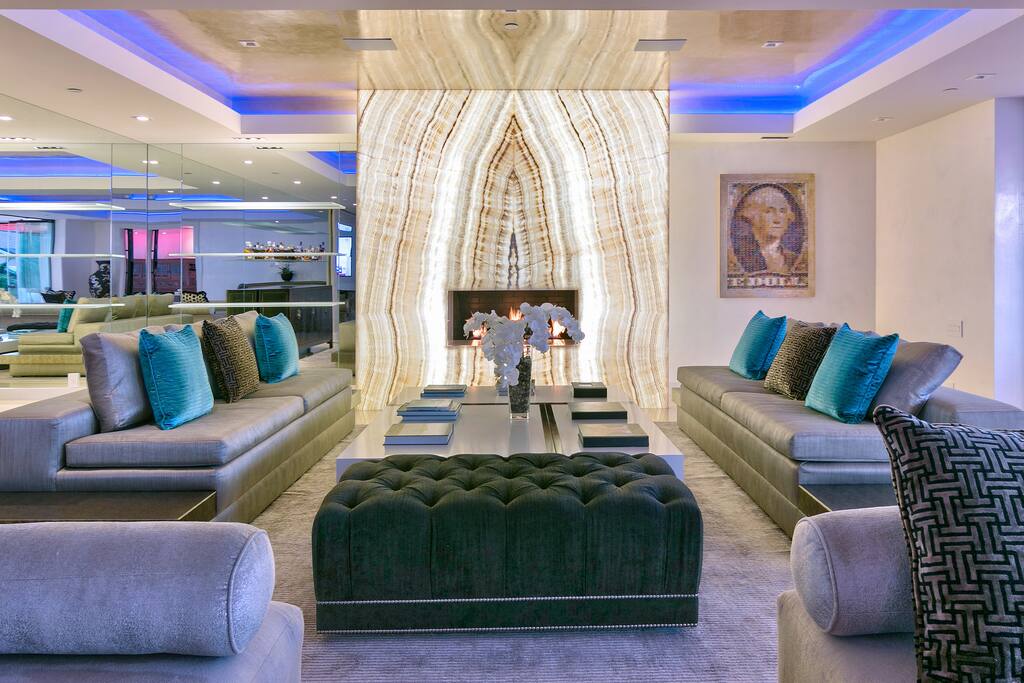 Showpiece white onyx fireplace in the living room.