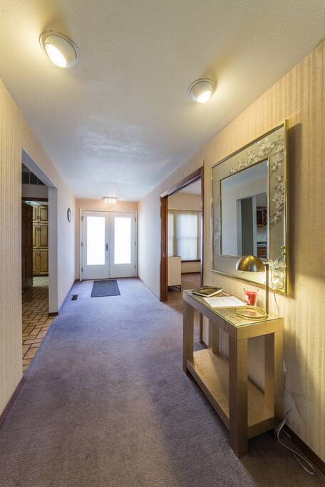 View of the entryway and doorways to the kitchen and front bedroom