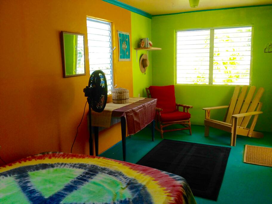 A roomy bedroom with comfy chairs and good books to read