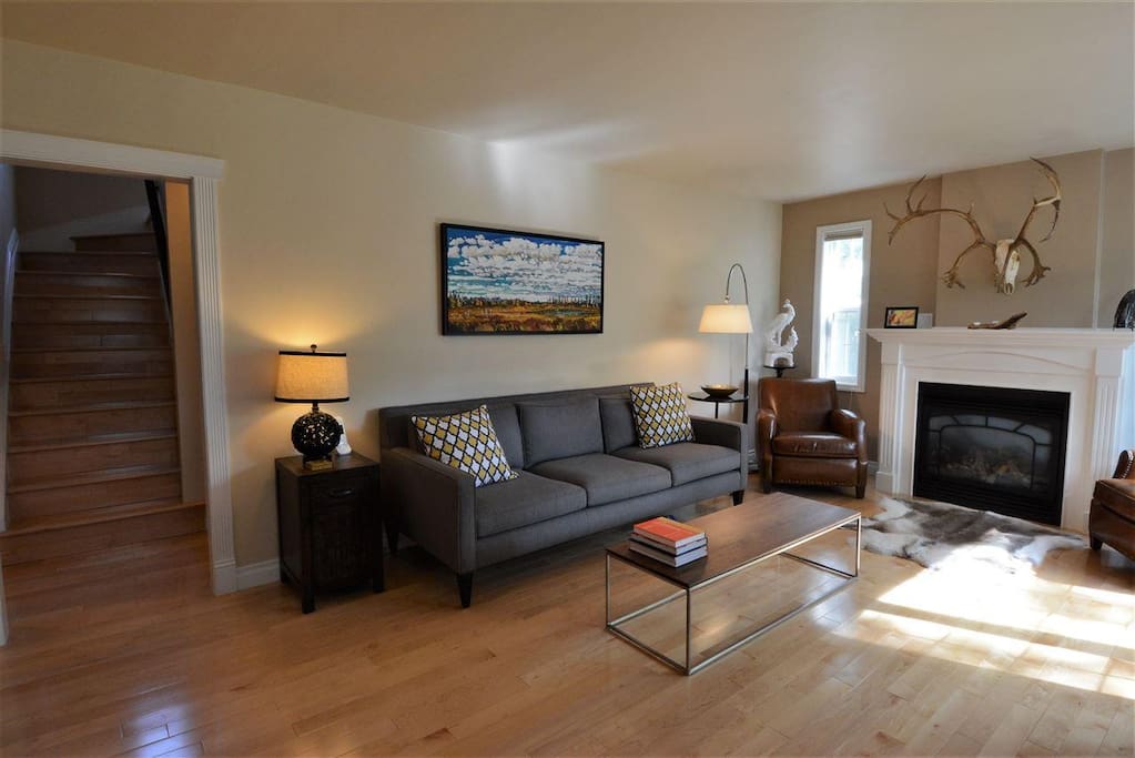 A bright and spacious living room with cozy gas fireplace.