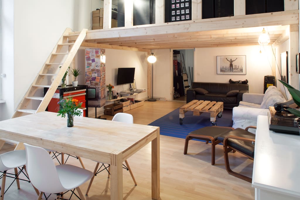 The common area is 40m2, includes a dining table, vinyl player, 2 sofas, a large TV. There is an additional bed above in the wooden mezannine. Feel at home!