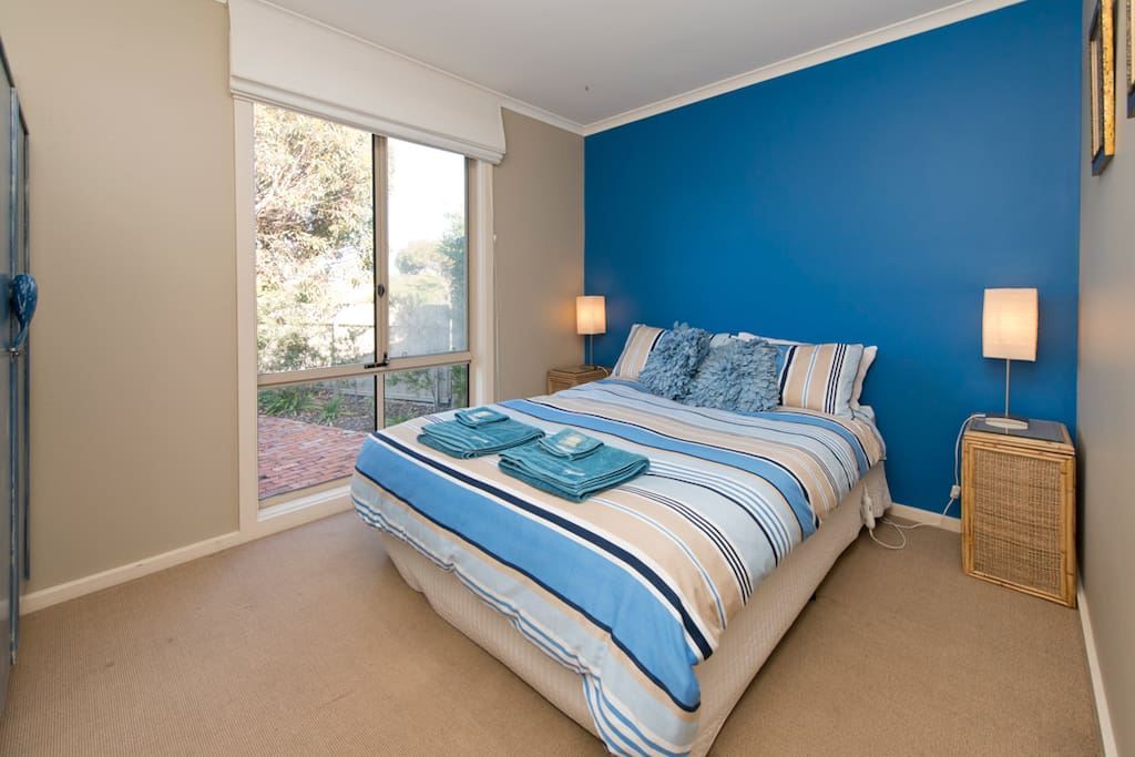 Spacious main bedroom, looking out to gardens