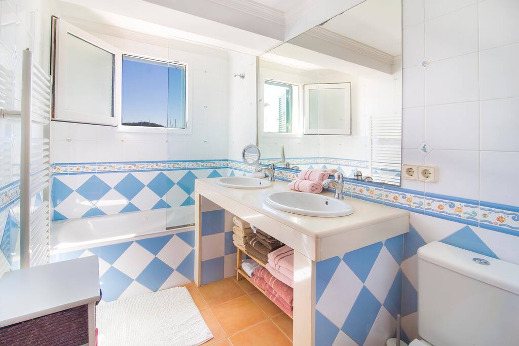 spacious bathroom with sea views
