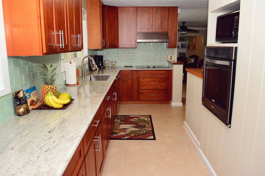 New kitchen with granite and sea glass tile.