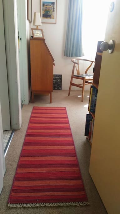 View from the front door looking in - bathroom and kitchen doors are to the left and the living space is to the right.