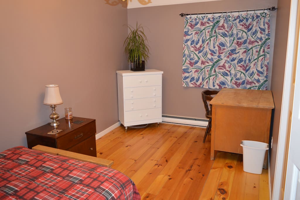 Spacious master bedroom with beautiful knotty-pine floor
