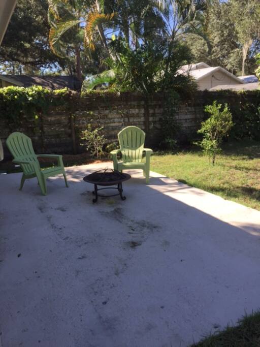 Deck area with fire pit on side of guest house.
