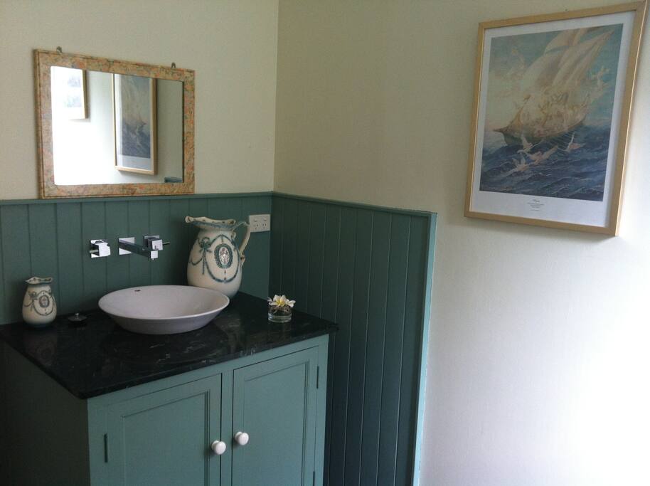 Bath, shower, toilet with marble top. Country look.