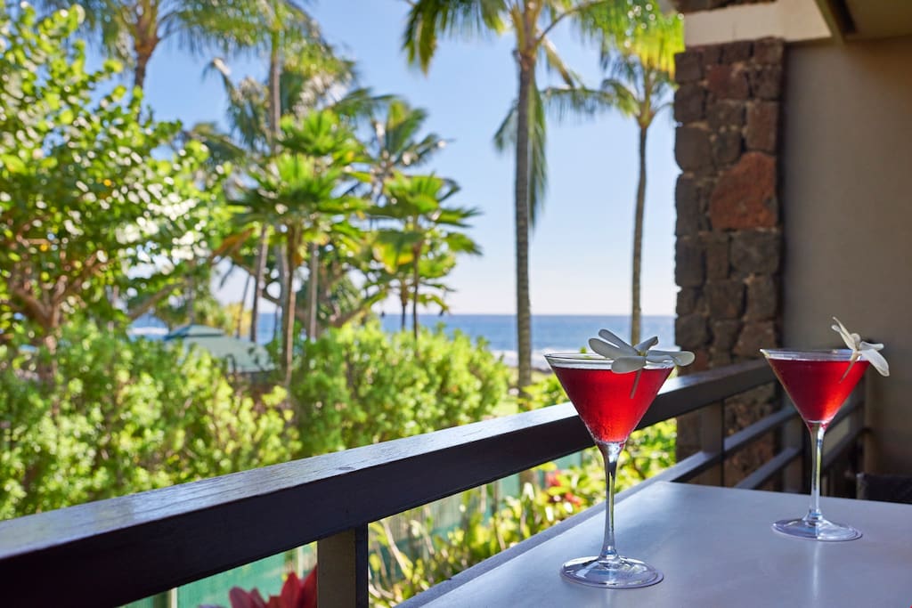 Enjoy a gorgeous view of a lush garden and of the glimmering sea from your balcony.