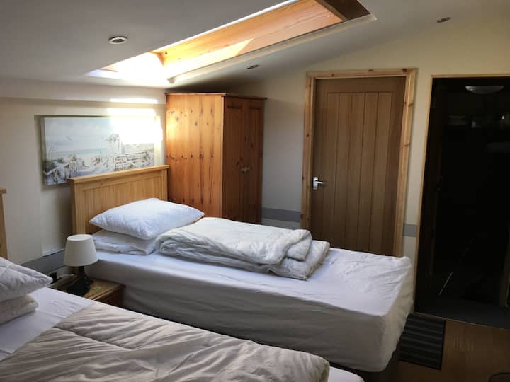 Twin Bedroom with door leading to a box room with one set of bunk beds