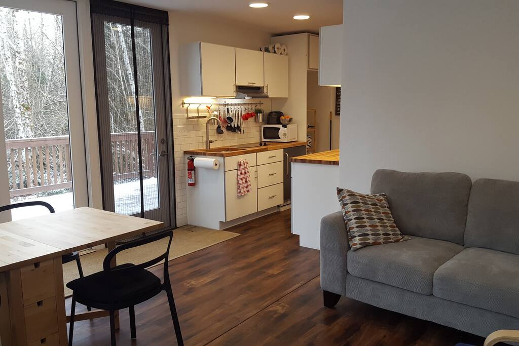 Looking from the living room to the kitchen and deck.