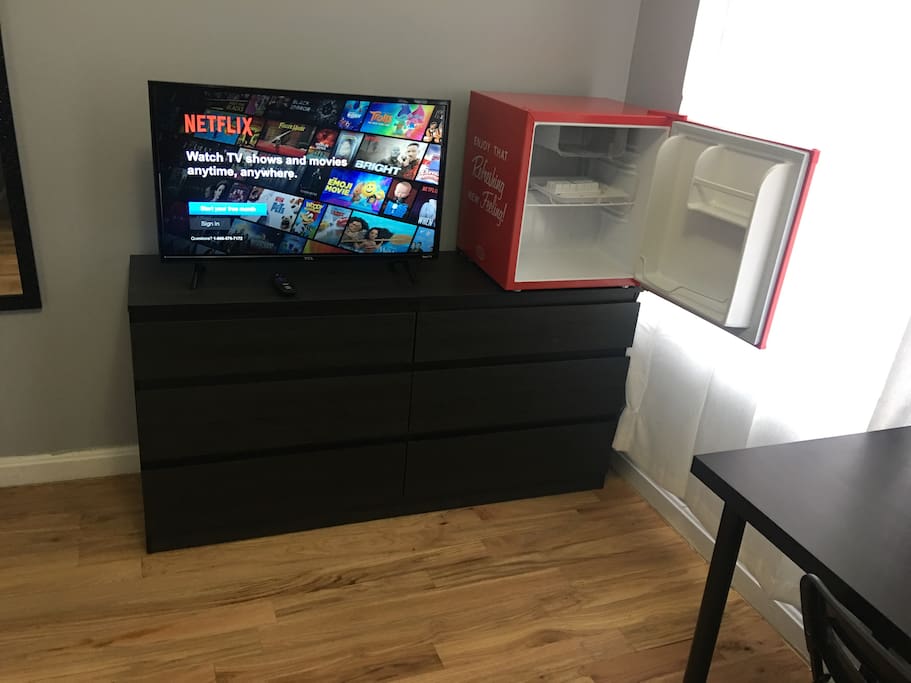 Bedroom with minifridge and smart TV