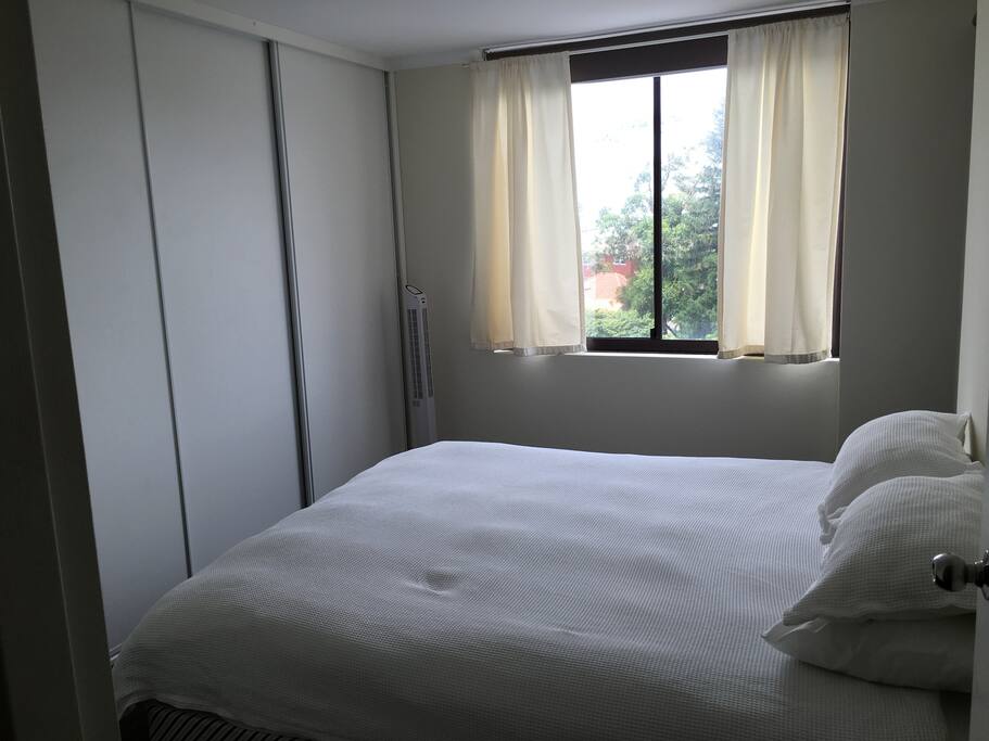 King sized bed with built-in wardrobes