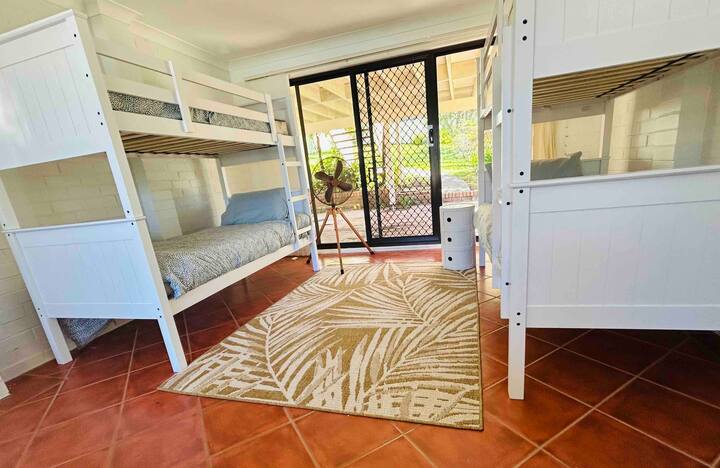 Ultimate kids bunk room with double bunks, the comfiest bean bags, foosball/billiards/ice hockey table, TV and games cabinet.