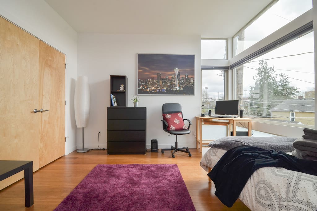 Large, modern room with workspace. Floor to ceiling windows! Sunshine pours into your private room. Tons of storage space: dresser and giant closet! We provide a cozy robe for your stay! As well as hangers, iron+board, extra linens, and a laundry bin. Free use of washer, dryer, and detergent!