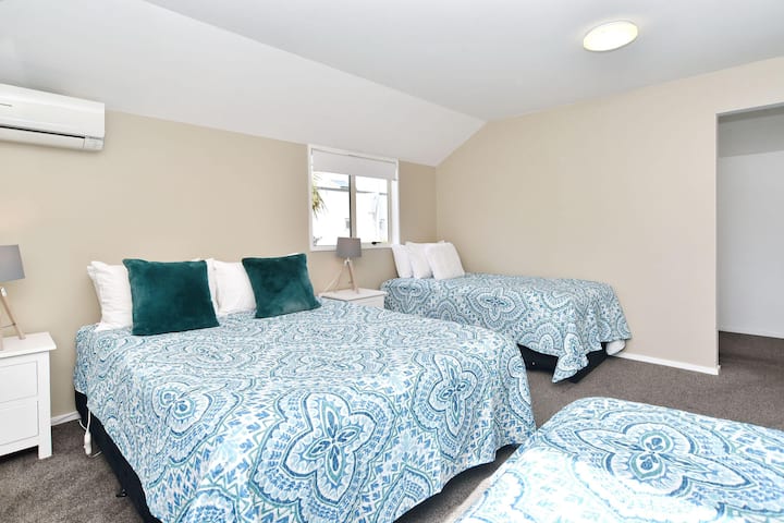 El dormitorio 1, arriba, es el dormitorio principal. Viene con baño privado adjunto, una cama tamaño queen, dos camas individuales y un trundler.