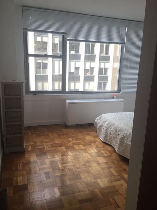 Bedroom has large windows and a Full bed. Please note: there is no door, it's an open, flowing space adjoining the living room.