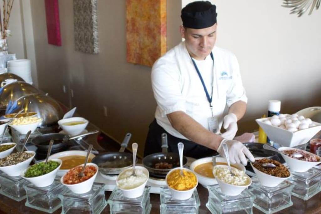 Breakfast buffet in the main building with indoor and outdoor terrace seating.