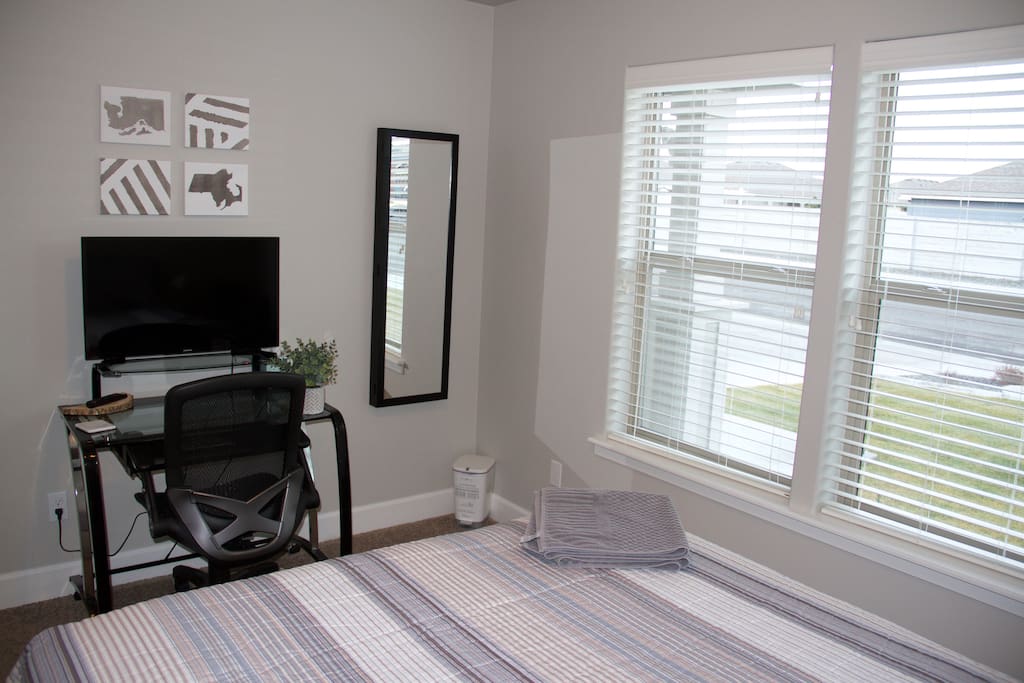 Both bedrooms have natural light & come with modern style writing desks, 32" Smart HD Samsung TVs (Netflix included) & full size mirrors.