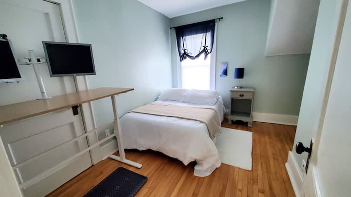 全尺寸床，配备记忆泡沫床垫、衣架和休息/立式办公桌