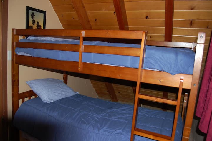 Bedroom #3: Upstairs “Bunk Bed Room” with twin over twin bunk beds (maximum weight 185 lbs. each), Playstation 2 with assorted games, new etched wood flooring, & hidden bonus space for a pillow fort behind the beds!