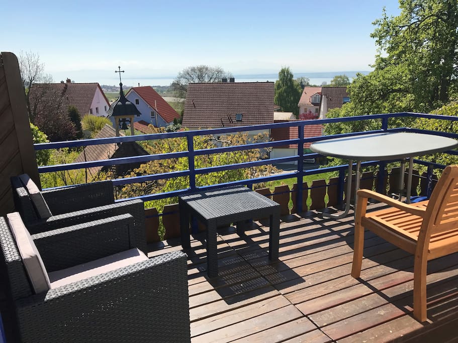 Balkonansicht mit See- und Alpenpanorama und Lounge-Möbeln