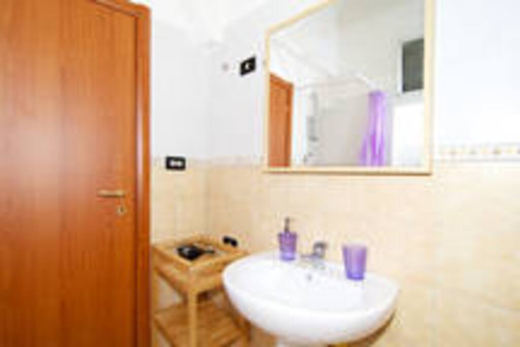 bathroom with shower, bidet, toilet, faucet, washing machine