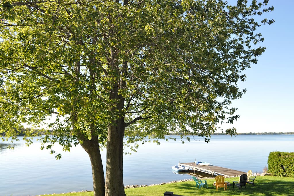 Full sun waterfront with shadey area under the tree. Shallow entry with sandy bottom. Lake front outdoor fire pit.