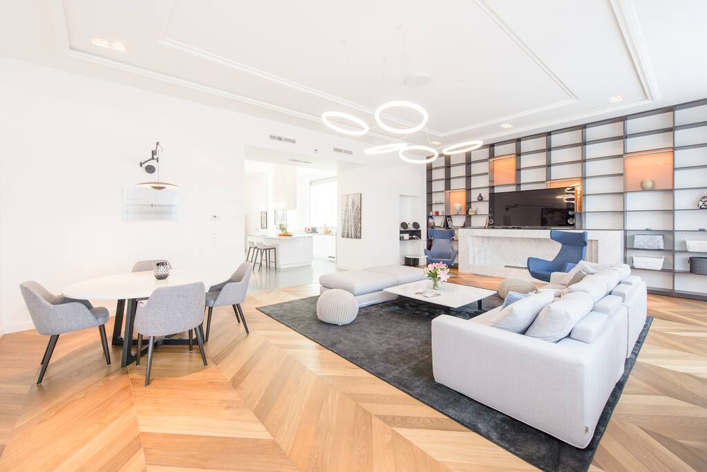 Large living & dining area with Bang & Olufsen speakers, ipad, & 80 inch Sony smart TV