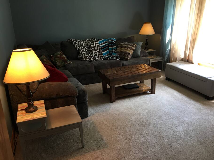 The living room has a wraparound sofa with plenty of seating, as well as a window seat - this room also has a TV with Google Chromecast and an Xbox One X to play DVDs.
