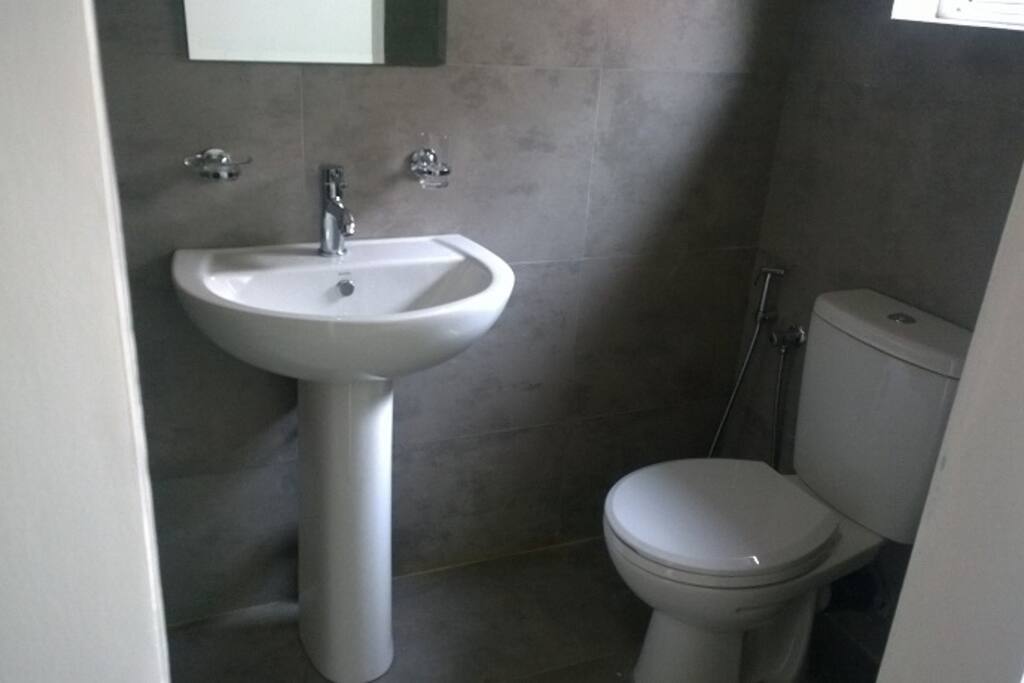En suite - Very clean. Neutral earthy color palette. Hot water.