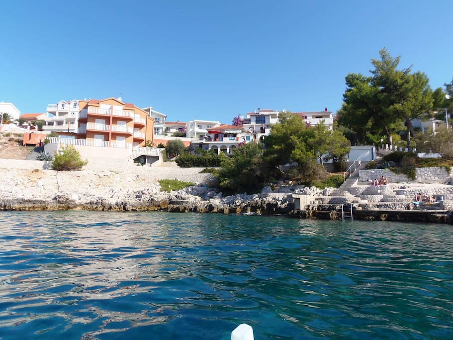 Second view from the sea to the building of apartment.