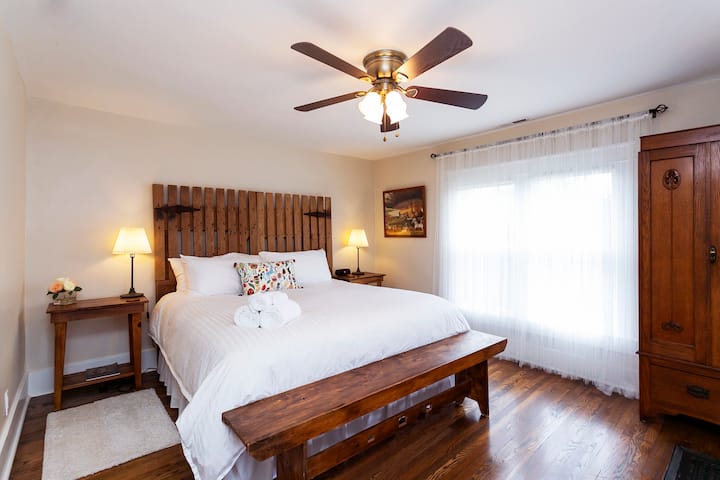 The Minnie Pearl room has a king size bed  with a head board custom-made from an antique mule gate.