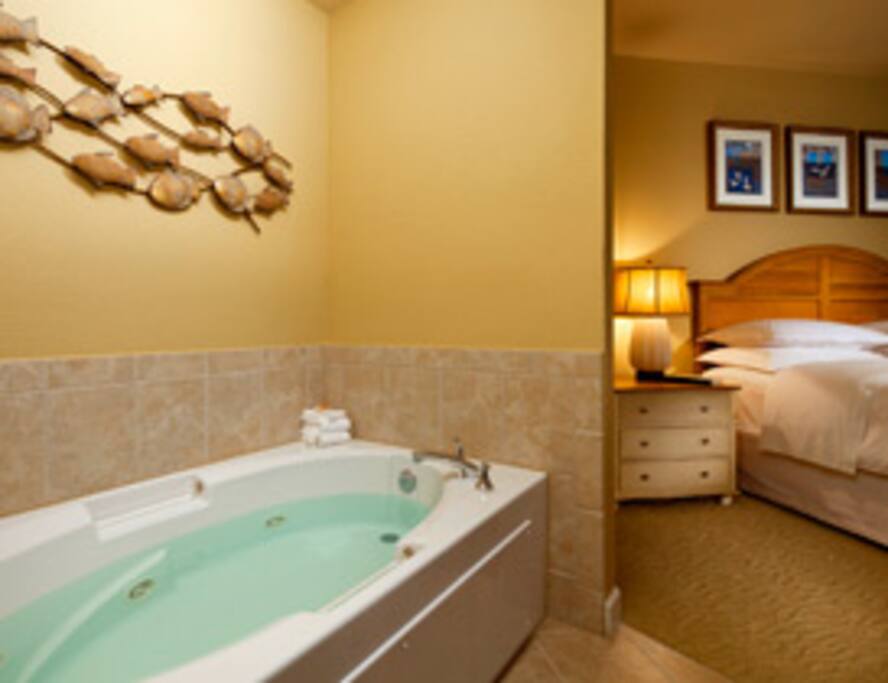 Tiled bathroom with whirlpooltub and 2 sinks