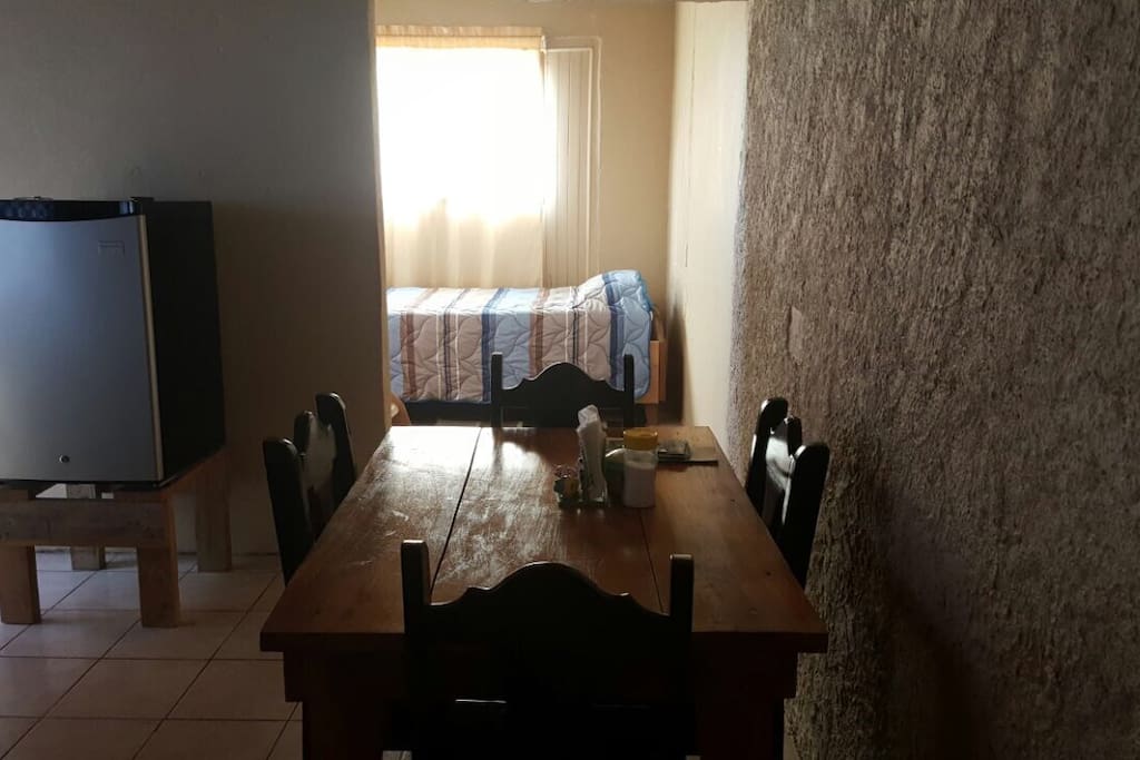 Mesa con cuatro sillas para disfrutar su comida.